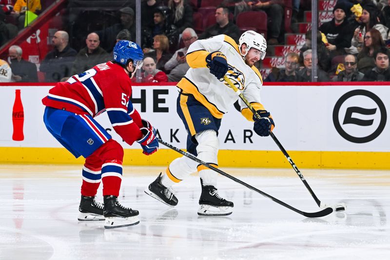 Dec 10, 2023; Montreal, Quebec, CAN; Nashville Predators center Yakov Trenin (13) shoots the puck as Montreal Canadiens defenseman Justin Barron (52) defends during the second period at Bell Centre. Mandatory Credit: David Kirouac-USA TODAY Sports