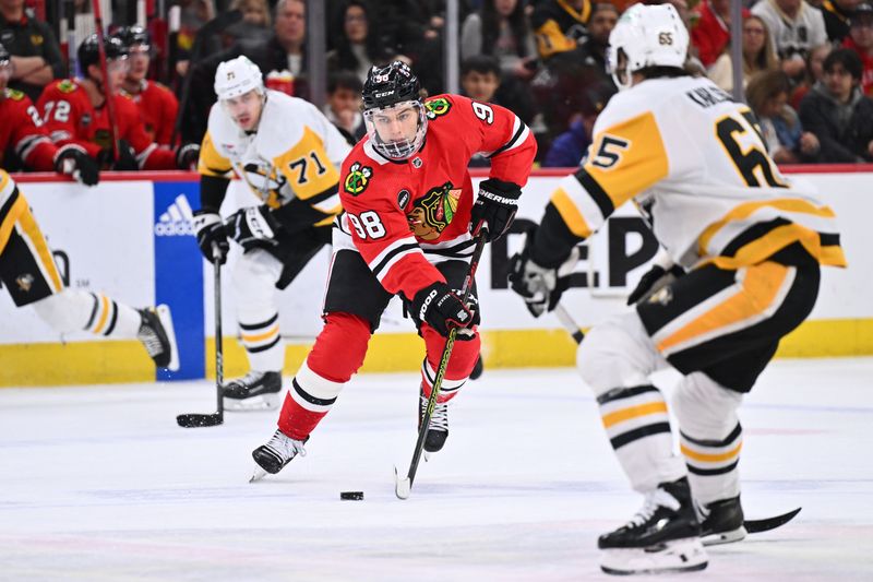 Feb 15, 2024; Chicago, Illinois, USA; Chicago Blackhawks forward Connor Bedard (98) controls the puck in the first period against the Pittsburgh Penguins at United Center. Mandatory Credit: Jamie Sabau-USA TODAY Sports