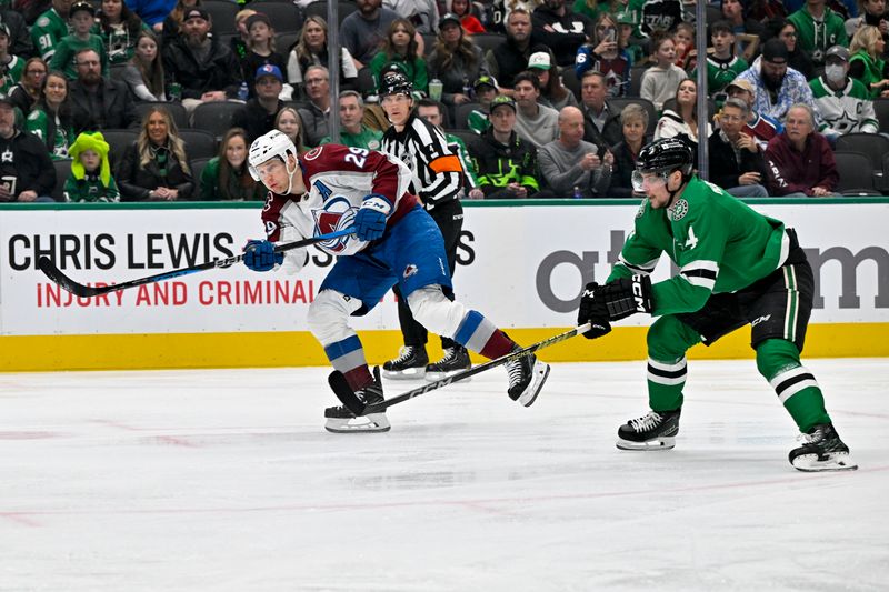 Jan 4, 2024; Dallas, Texas, USA; Colorado Avalanche center Nathan MacKinnon (29) shoots the puck past Dallas Stars defenseman Miro Heiskanen (4) during the first period at the American Airlines Center. Mandatory Credit: Jerome Miron-USA TODAY Sports