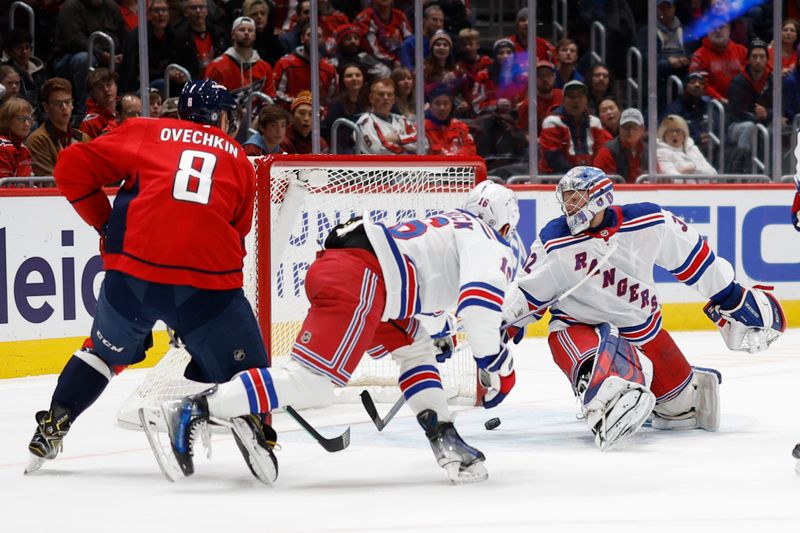 Jan 4, 2025; Washington, District of Columbia, USA; New York Rangers goaltender Jonathan Quick (32) makes a save in front of Rangers center Vincent Trocheck (16) and Washington Capitals left wing Alex Ovechkin (8) in the first period at Capital One Arena. Mandatory Credit: Geoff Burke-Imagn Images