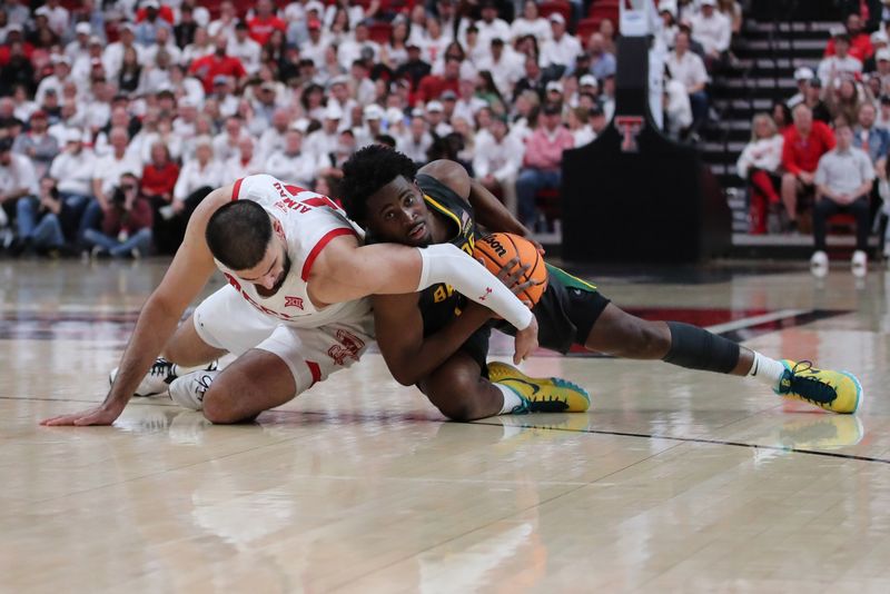 Jan 17, 2023; Lubbock, Texas, USA;  Baylor Bears guard Adam Flagler (10) and Texas Tech Red Raiders forward Fardaws Aimaq (11) wrestle over a loose ball in the second half at United Supermarkets Arena. Mandatory Credit: Michael C. Johnson-USA TODAY Sports