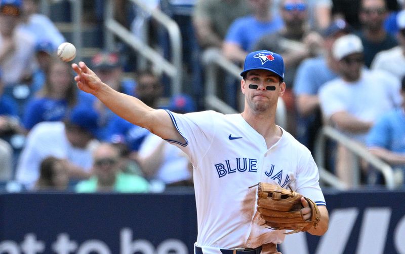 Jun 6, 2024; Toronto, Ontario, CAN;  Toronto Blue Jays third baseman Ernie Clement (28) throws to first base to force out Baltimore Orioles catcher James McCann (not shown) in the fifth inning at Rogers Centre. Mandatory Credit: Dan Hamilton-USA TODAY Sports