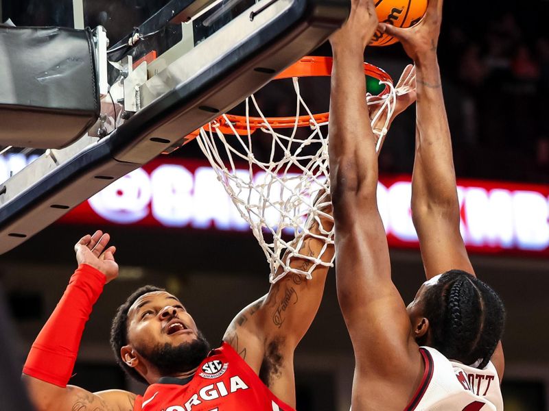 Mar 4, 2023; Columbia, South Carolina, USA; South Carolina Gamecocks center Tre-Vaughn Minott (4) dunks over Georgia Bulldogs forward Jailyn Ingram (15) in the first half at Colonial Life Arena. Mandatory Credit: Jeff Blake-USA TODAY Sports