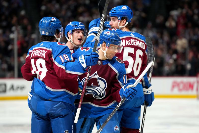 Jan 24, 2023; Denver, Colorado, USA; Colorado Avalanche center Andrew Cogliano (11) celebrates his goal with center Alex Newhook (18) and defenseman Kurtis MacDermid (56) in the second period against the Washington Capitals at Ball Arena. Mandatory Credit: Ron Chenoy-USA TODAY Sports