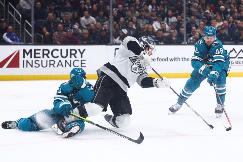 Dec 27, 2023; Los Angeles, California, USA; Los Angeles Kings center Phillip Danault (24) gets tangled up with San Jose Sharks right wing Mitchell Russell (64) during the second period of a game at Crypto.com Arena. Mandatory Credit: Jessica Alcheh-USA TODAY Sports