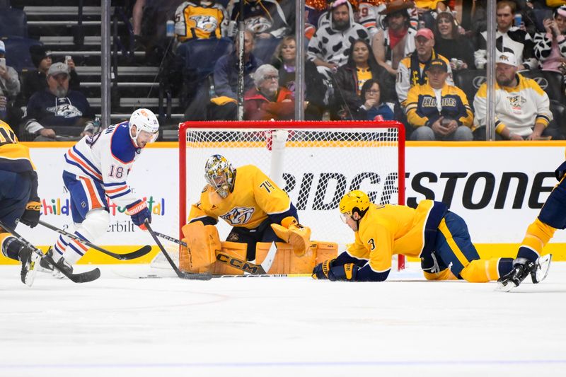 Oct 31, 2024; Nashville, Tennessee, USA;  Nashville Predators goaltender Juuse Saros (74) blocks the shot of Edmonton Oilers left wing Zach Hyman (18) during the first period at Bridgestone Arena. Mandatory Credit: Steve Roberts-Imagn Images