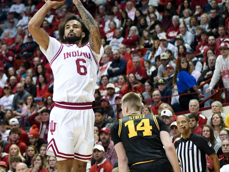 Jan 17, 2026; Bloomington, Indiana, USA; Indiana Hoosiers guard Tayton Conerway (6) shoots the ball past Iowa Hawkeyes guard Bennett Stirtz (14) during the first half at Simon Skjodt Assembly Hall. Mandatory Credit: Robert Goddin-Imagn Images