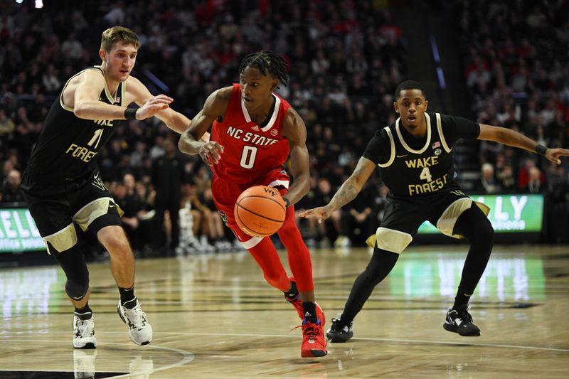 Jan 28, 2023; Winston-Salem, North Carolina, USA; North Carolina State Wolfpack guard Terquavion Smith (0) drives between Wake Forest Demon Deacons forward Andrew Carr (11) and guard Daivien Williamson (4) during the second half at Lawrence Joel Veterans Memorial Coliseum. Mandatory Credit: William Howard-USA TODAY Sports