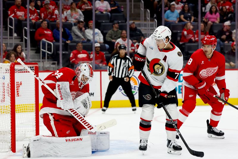 Oct 4, 2024; Detroit, Michigan, USA;  Detroit Red Wings goaltender Alex Lyon (34) makes a save in front of Ottawa Senators defenseman Thomas Chabot (72) in the first period at Little Caesars Arena. Mandatory Credit: Rick Osentoski-Imagn Images