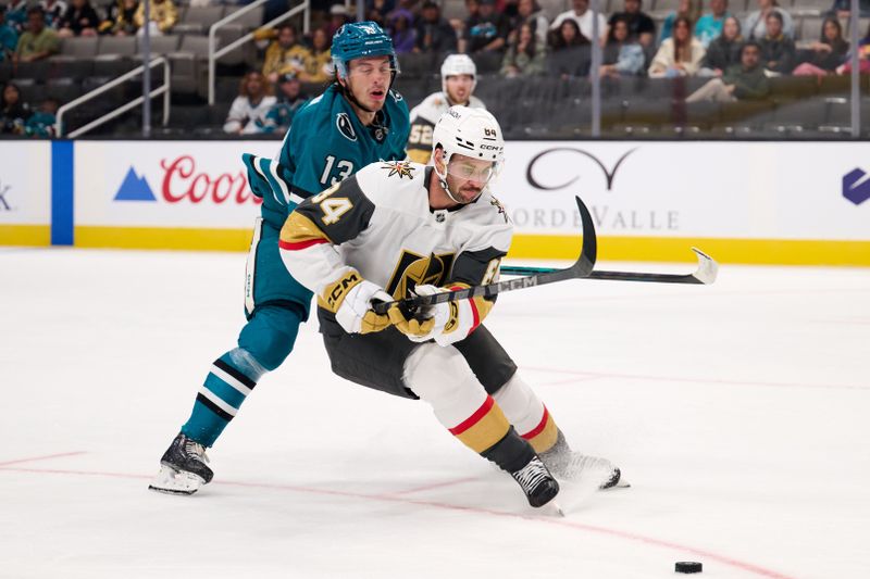 Sep 21, 2025; San Jose, California, USA; Vegas Golden Knights defenseman Jeremy Davies (84) controls the puck against San Jose Sharks left wing Quentin Musty (13) during the second period at SAP Center at San Jose. Mandatory Credit: Robert Edwards-Imagn Images