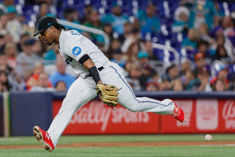 Jun 4, 2023; Miami, Florida, USA; Miami Marlins third baseman Jean Segura (9) cannot catch a ground ball hit by Oakland Athletics catcher Shea Langeliers (not pictured) during the third inning at loanDepot Park. Mandatory Credit: Sam Navarro-USA TODAY Sports