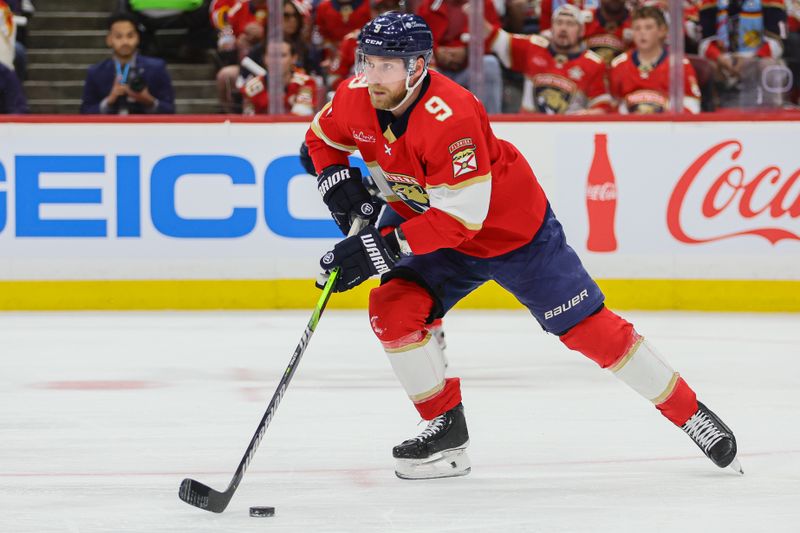 Apr 21, 2024; Sunrise, Florida, USA; Florida Panthers center Sam Bennett (9) moves the puck against the Tampa Bay Lightning during the second period in game one of the first round of the 2024 Stanley Cup Playoffs at Amerant Bank Arena. Mandatory Credit: Sam Navarro-USA TODAY Sports