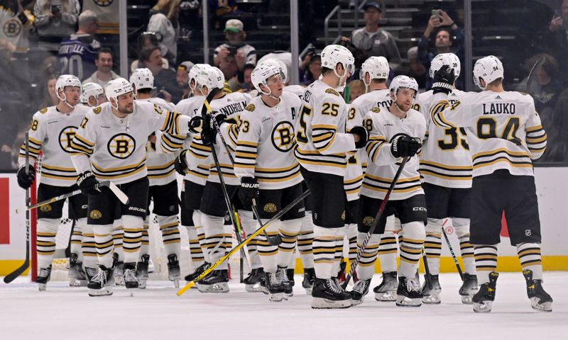 Oct 21, 2023; Los Angeles, California, USA; Boston Bruins players celebrate after defeating the Los Angeles Kings at Crypto.com Arena. Mandatory Credit: Alex Gallardo-USA TODAY Sports