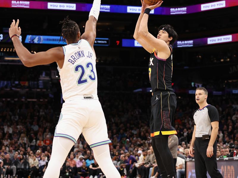 PHOENIX, ARIZONA - NOVEMBER 15: Yuta Watanabe #18 of the Phoenix Suns attempts a three-point shot over Troy Brown Jr. #23 of the Minnesota Timberwolves during the second half of the NBA game at Footprint Center on November 15, 2023 in Phoenix, Arizona. The Suns defeated the Timberwolves 133-115. NOTE TO USER: User expressly acknowledges and agrees that, by downloading and or using this photograph, User is consenting to the terms and conditions of the Getty Images License Agreement.  (Photo by Christian Petersen/Getty Images)