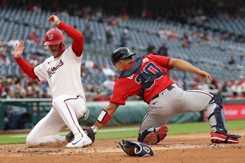 Sep 16, 2025; Washington, District of Columbia, USA; Washington Nationals third base Brady House (55) scores a run on a sacrifice fly by Nationals shortstop CJ Abrams (not pictured) ahead of a tag by Atlanta Braves catcher Drake Baldwin (30) during the second inning at Nationals Park. Mandatory Credit: Geoff Burke-Imagn Images