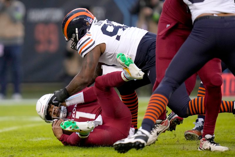 Chicago Bears defensive tackle Justin Jones sacks Arizona Cardinals quarterback Kyler Murray during the first half of an NFL football game Sunday, Dec. 24, 2023, in Chicago. (AP Photo/Erin Hooley)