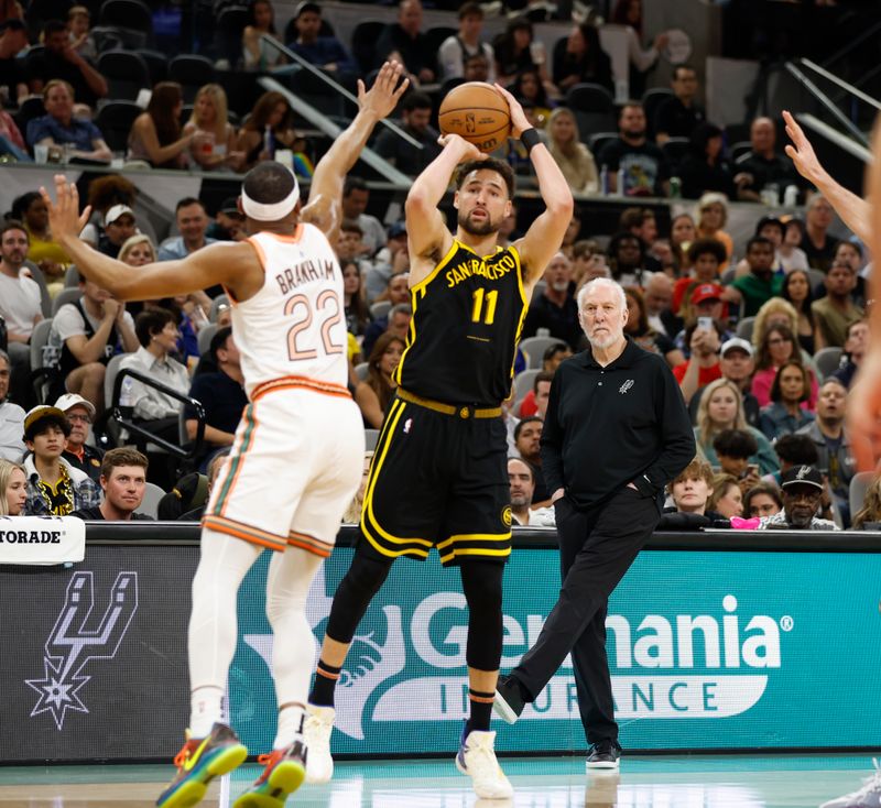 SAN ANTONIO, TX - MARCH 31:  Klay Thompson #11 of the Golden State Warriors shoots from the three-point line against Malaki Branham #22 of the San Antonio Spurs in the first half at Frost Bank Center on March 31, 2024 in San Antonio, Texas. NOTE TO USER: User expressly acknowledges and agrees that, by downloading and or using this photograph, User is consenting to terms and conditions of the Getty Images License Agreement. (Photo by Ronald Cortes/Getty Images)