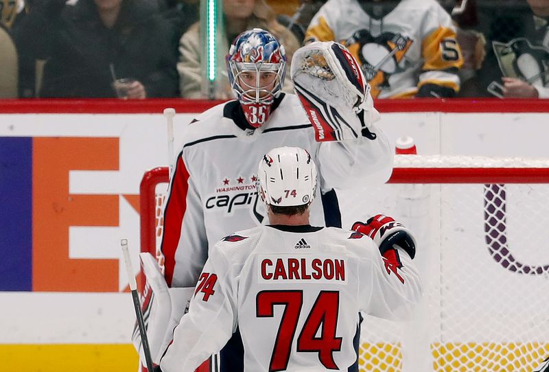 Jan 2, 2024; Pittsburgh, Pennsylvania, USA;  Washington Capitals goaltender Darcy Kuemper (35) and defenseman John Carlson (74) celebrate after defeating the Pittsburgh Penguins at PPG Paints Arena. Mandatory Credit: Charles LeClaire-USA TODAY Sports