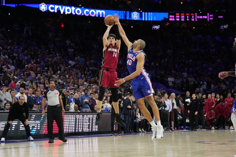 PHILADELPHIA, PA - APRIL 17: Nicolas Batum #40 of the Philadelphia 76ers blocks the shot by Tyler Herro #14 of the Miami Heat during the game during the 2024 NBA Play-In Tournament on April 17, 2024 at the Wells Fargo Center in Philadelphia, Pennsylvania NOTE TO USER: User expressly acknowledges and agrees that, by downloading and/or using this Photograph, user is consenting to the terms and conditions of the Getty Images License Agreement. Mandatory Copyright Notice: Copyright 2024 NBAE (Photo by Jesse D. Garrabrant/NBAE via Getty Images)