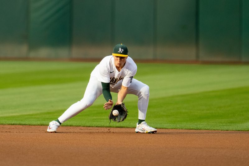Aug 5, 2024; Oakland, California, USA;  Oakland Athletics second baseman Zack Gelof (20) fields a ground ball against the Chicago White Sox during the first inning at Oakland-Alameda County Coliseum. Mandatory Credit: Neville E. Guard-USA TODAY Sports