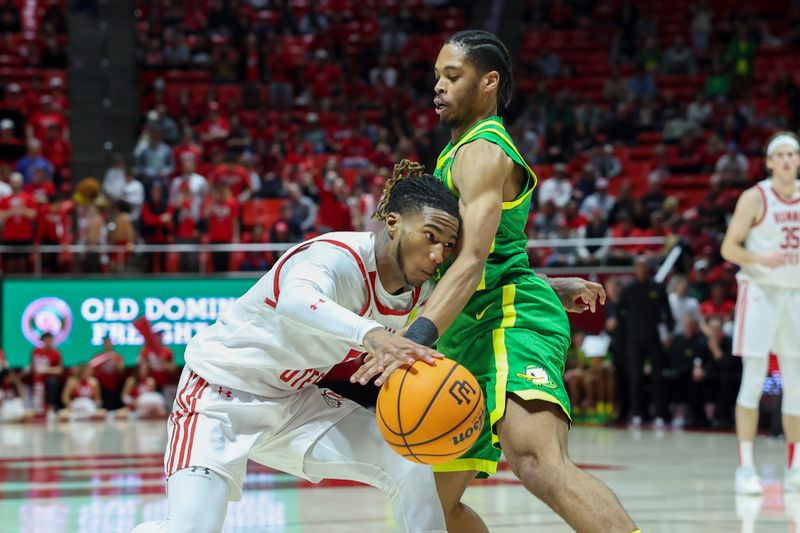 Jan 21, 2024; Salt Lake City, Utah, USA; Oregon Ducks guard Jermaine Couisnard (5) dribbles into Oregon Ducks guard Keeshawn Barthelemy (9) during the second half at Jon M. Huntsman Center. Mandatory Credit: Rob Gray-USA TODAY Sports