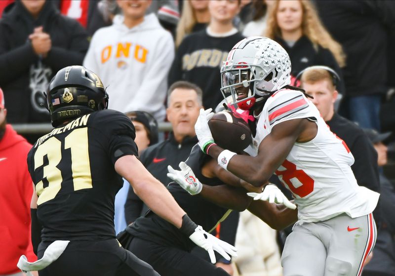 Oct 14, 2023; West Lafayette, Indiana, USA;  Ohio State Buckeyes wide receiver Marvin Harrison Jr. (18) catches a pass against Purdue Boilermakers defensive back Markevious Brown (1) during the first half at Ross-Ade Stadium. Mandatory Credit: Robert Goddin-USA TODAY Sports