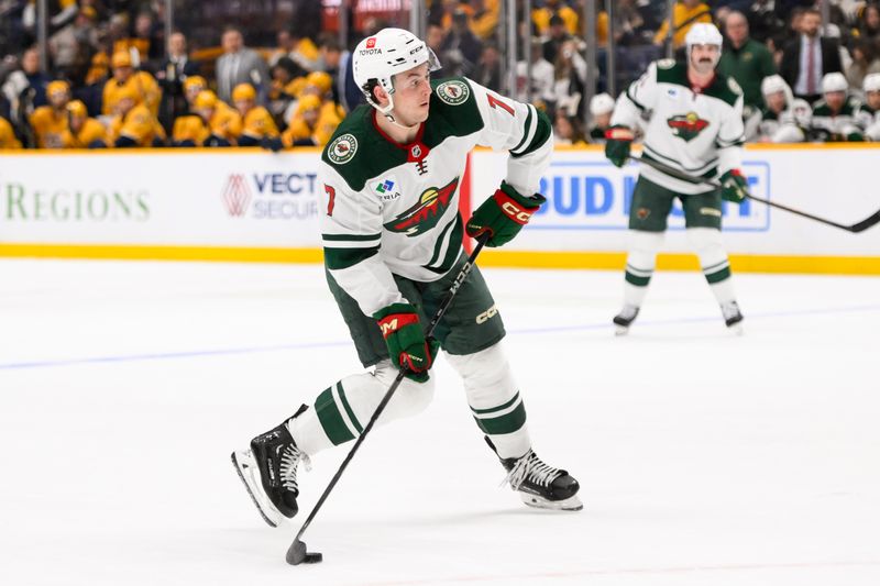 Jan 18, 2025; Nashville, Tennessee, USA;  Minnesota Wild defenseman Brock Faber (7) takes a shot on goal against the Nashville Predators during the second period at Bridgestone Arena. Mandatory Credit: Steve Roberts-Imagn Images