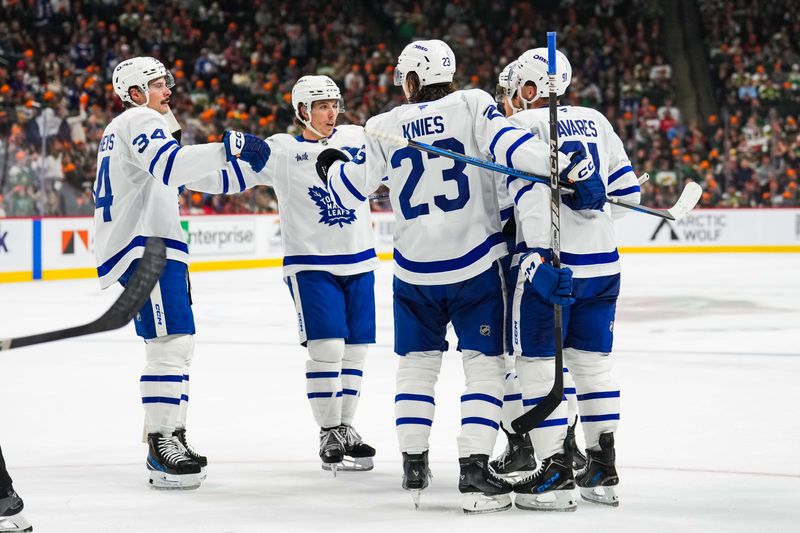 Nov 3, 2024; Saint Paul, Minnesota, USA; Toronto Maple Leafs right wing William Nylander (not pictured) celebrates his goal with left wing Matthew Knies (23), right wing Mitch Marner (16), center Auston Matthews (34) and center John Tavares (91) during the first period against the Minnesota Wild at Xcel Energy Center. Mandatory Credit: Brace Hemmelgarn-Imagn Images