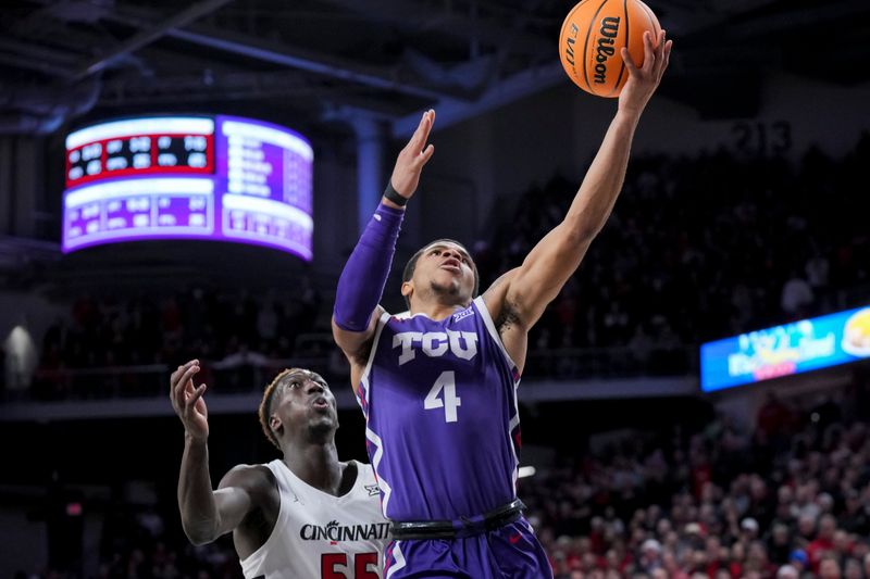 Jan 16, 2024; Cincinnati, Ohio, USA;  TCU Horned Frogs guard Jameer Nelson Jr. (4) drives to the basket against Cincinnati Bearcats forward Aziz Bandaogo (55) in the second half at Fifth Third Arena. Mandatory Credit: Aaron Doster-USA TODAY Sports