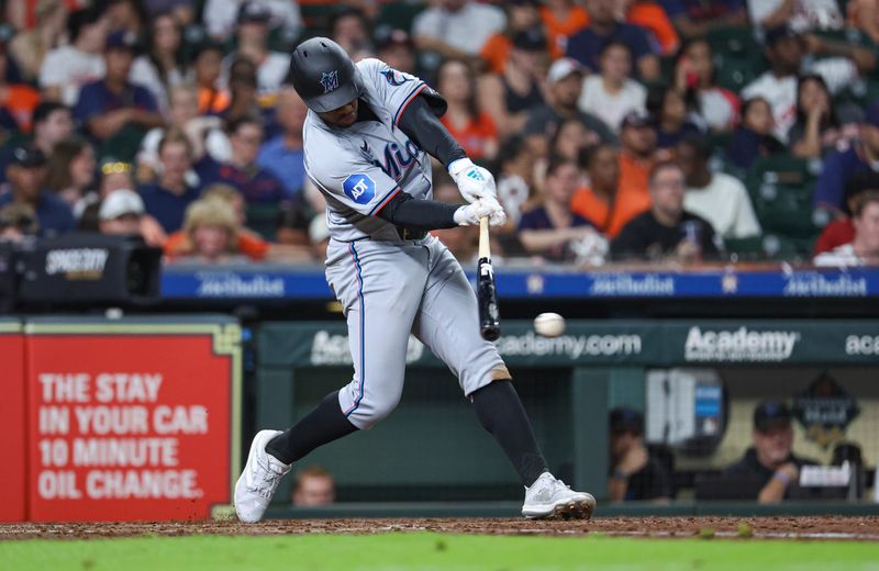 Jul 10, 2024; Houston, Texas, USA; Miami Marlins shortstop Xavier Edwards (63) hits an RBI sinlge during the fifth inning against the Houston Astros at Minute Maid Park. Mandatory Credit: Troy Taormina-USA TODAY Sports