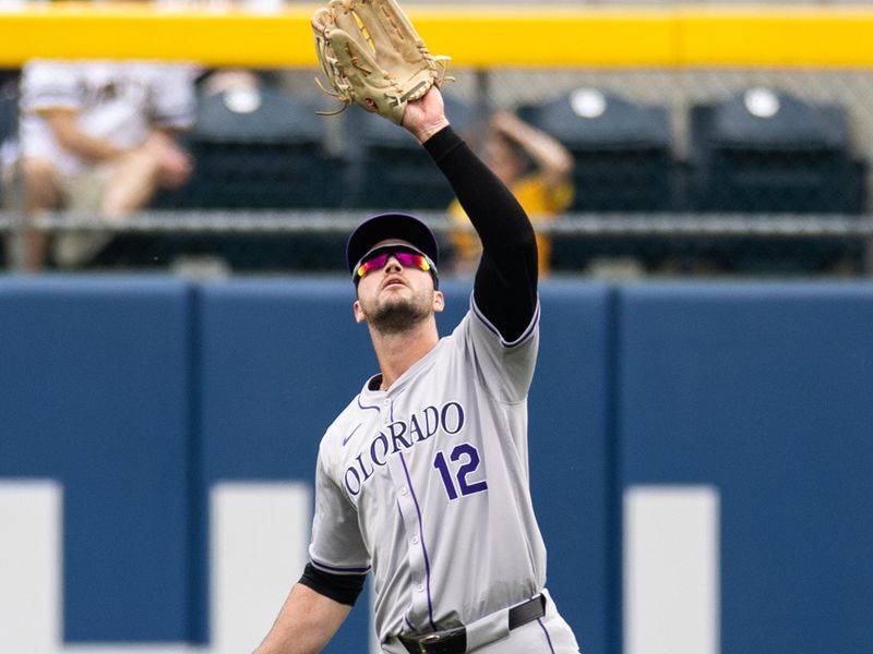 May 5, 2024; Pittsburgh, Pennsylvania, USA; Colorado Rockies right fielder Sean Bouchard (12) catches a fly ball for the second out of the second inning against the Pittsburgh Pirates at PNC Park. Mandatory Credit: Scott Galvin-USA TODAY Sports