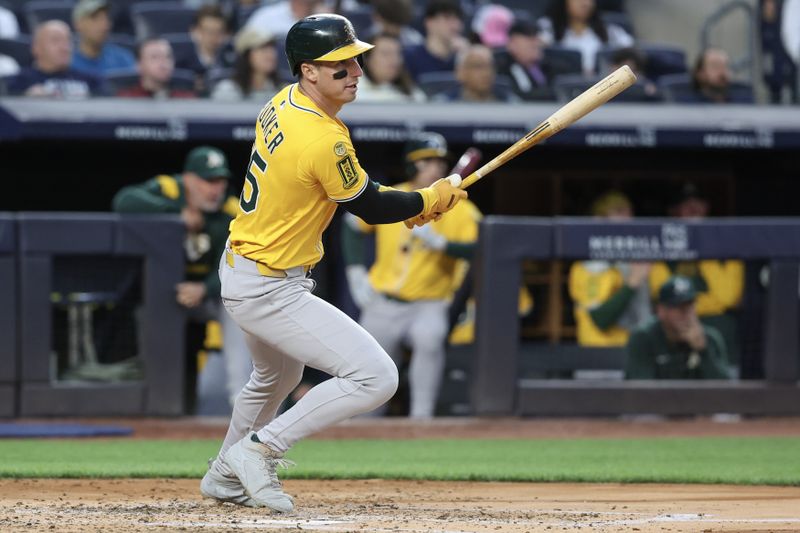 Jun 27, 2025; Bronx, New York, USA;  Athletics designated hitter Brent Rooker (25) hits a single in the third inning against the New York Yankees at Yankee Stadium. Mandatory Credit: Wendell Cruz-Imagn Images
