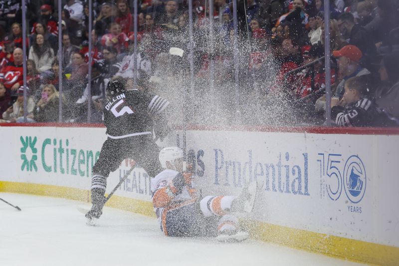 Apr 13, 2025; Newark, New Jersey, USA; New Jersey Devils defenseman Brenden Dillon (5) hits New York Islanders center Casey Cizikas (53) during the first period at Prudential Center. Mandatory Credit: Ed Mulholland-Imagn Images