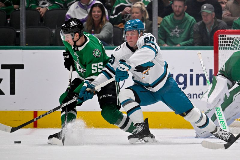 Nov 20, 2024; Dallas, Texas, USA; Dallas Stars defenseman Thomas Harley (55) and San Jose Sharks left wing Fabian Zetterlund (20) battle for control of the puck during the second period at the American Airlines Center. Mandatory Credit: Jerome Miron-Imagn Images