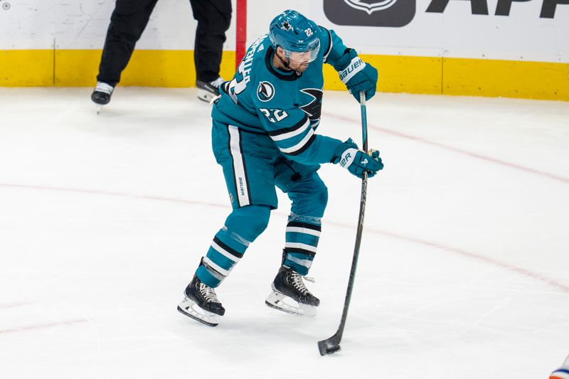 Dec 28, 2023; San Jose, California, USA; San Jose Sharks center Ryan Carpenter (22) shoots the puck during the third period against the Edmonton Oilers at SAP Center at San Jose. Mandatory Credit: Neville E. Guard-USA TODAY Sports