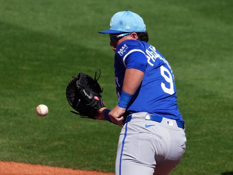 Mar 8, 2024; Surprise, Arizona, USA; Kansas City Royals first baseman Vinnie Pasquantino (9) fields a ground ball against the Texas Rangers during the second inning at Surprise Stadium. Mandatory Credit: Joe Camporeale-USA TODAY Sports