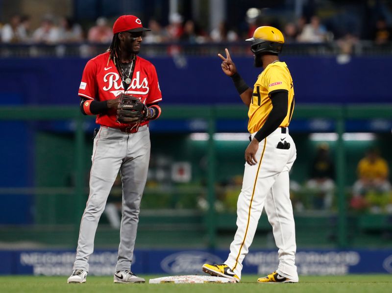 Aug 23, 2024; Pittsburgh, Pennsylvania, USA;  Cincinnati Reds shortstop Elly De La Cruz (left) and Pittsburgh Pirates right fielder Bryan De La Cruz (right) talk at second base during the fifth inning at PNC Park. Mandatory Credit: Charles LeClaire-USA TODAY Sports