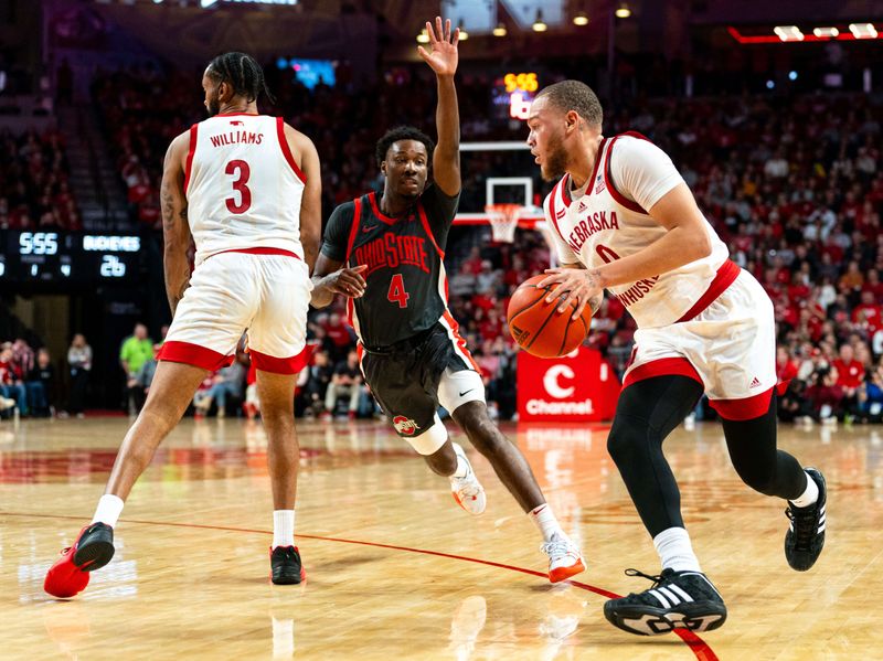 Jan 23, 2024; Lincoln, Nebraska, USA; Nebraska Cornhuskers guard C.J. Wilcher (0) drives against Ohio State Buckeyes guard Dale Bonner (4) during the first half at Pinnacle Bank Arena. Mandatory Credit: Dylan Widger-USA TODAY Sports