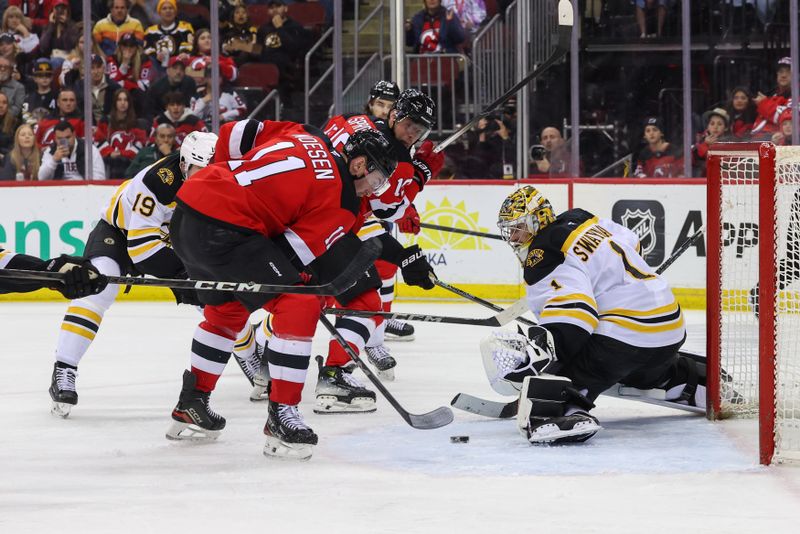 Apr 8, 2025; Newark, New Jersey, USA; New Jersey Devils right wing Stefan Noesen (11) scores a goal on Boston Bruins goaltender Jeremy Swayman (1) during the second period at Prudential Center. Mandatory Credit: Ed Mulholland-Imagn Images