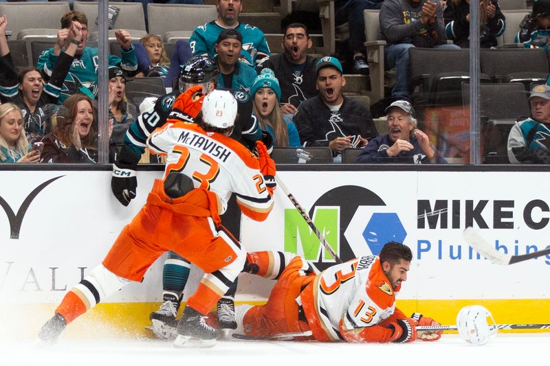 Oct 12, 2024; San Jose, California, USA; Anaheim Ducks center Robby Fabbri (13) loses his helmet as center Mason McTavish (23) and San Jose Sharks left winger Fabian Zetterlund (20) mix it up during the second period at SAP Center at San Jose. Mandatory Credit: D. Ross Cameron-Imagn Images