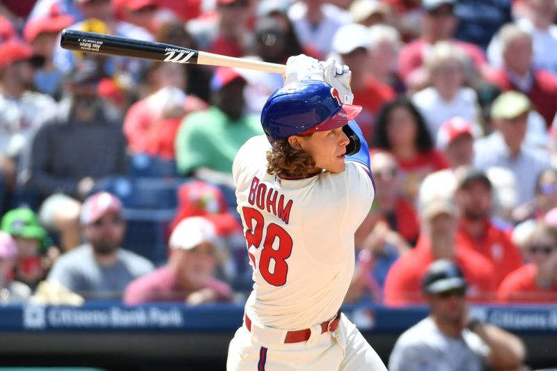 Apr 23, 2023; Philadelphia, Pennsylvania, USA; Philadelphia Phillies first baseman Alec Bohm (28) hits an RBI double against the Colorado Rockies during the seventh inning at Citizens Bank Park. Mandatory Credit: Eric Hartline-USA TODAY Sports