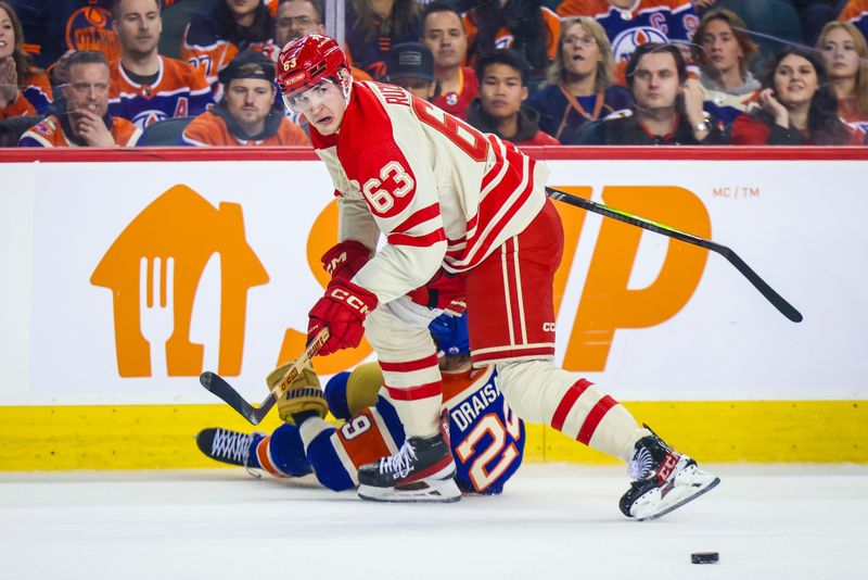 Jan 20, 2024; Calgary, Alberta, CAN; Calgary Flames center Adam Ruzicka (63) and Edmonton Oilers center Leon Draisaitl (29) battles for the puck during the first period at Scotiabank Saddledome. Mandatory Credit: Sergei Belski-USA TODAY Sports