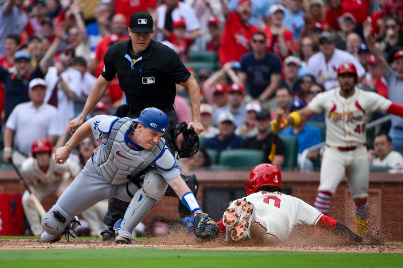 Jun 7, 2025; St. Louis, Missouri, USA;  St. Louis Cardinals shortstop Masyn Winn (0) slides safely past Los Angeles Dodgers catcher Will Smith (16) and scores during the eighth inning at Busch Stadium. Mandatory Credit: Jeff Curry-Imagn Images