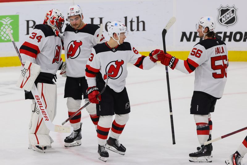 Nov 14, 2024; Sunrise, Florida, USA; New Jersey Devils left wing Jesper Bratt (63) celebrates with left wing Erik Haula (56) after the game against the Florida Panthers at Amerant Bank Arena. Mandatory Credit: Sam Navarro-Imagn Images