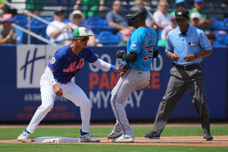 Mar 17, 2024; Port St. Lucie, Florida, USA;  Miami Marlins catcher Christian Bethancourt (25) get tagged out trying to reach third base by New York Mets third baseman Mark Vientos (27) in the third inning at Clover Park. Mandatory Credit: Jim Rassol-USA TODAY Sports