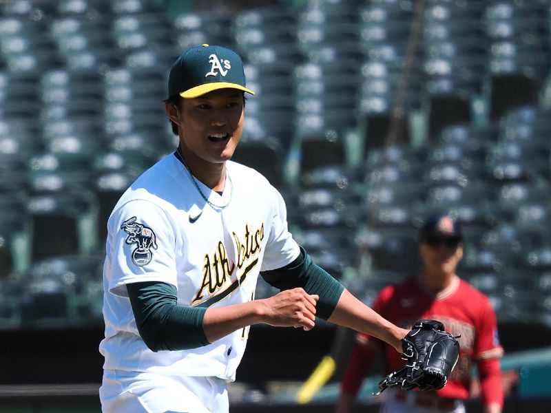 May 17, 2023; Oakland, California, USA; Oakland Athletics relief pitcher Shintaro Fujinami (11) reacts after striking out an Arizona Diamondbacks player to end the top of the eighth inning at Oakland-Alameda County Coliseum. Mandatory Credit: Kelley L Cox-USA TODAY Sports