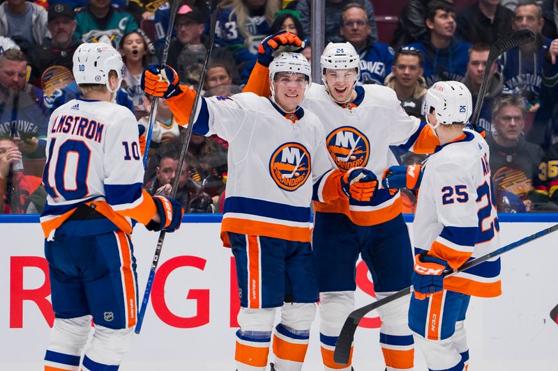 Nov 15, 2023; Vancouver, British Columbia, CAN; New York Islanders forward Simon Holmstrom (10) and forward Bo Horvat (14) and defenseman Scott Mayfield (24) and defenseman Sebastian Aho (25) celebrate Horvat   s goal against the Vancouver Canucks in the second period at Rogers Arena. Mandatory Credit: Bob Frid-USA TODAY Sports