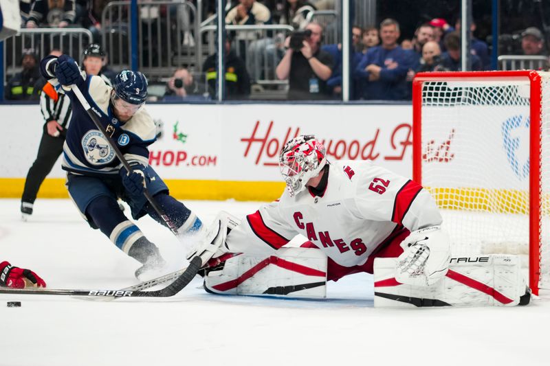 Nov 23, 2024; Columbus, Ohio, USA;  Carolina Hurricanes goaltender Pyotr Kochetkov (52) makes a save in net against Columbus Blue Jackets defenseman Ivan Provorov (9) in the overtime period at Nationwide Arena. Mandatory Credit: Aaron Doster-Imagn Images