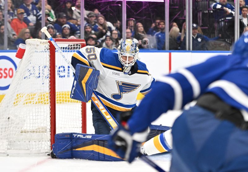 Jan 3, 2023; Toronto, Ontario, CAN; St. Louis Blues goalie Jordan Binnington (50) makes a save against the Toronto Maple Leafs in the first period at Scotiabank Arena. Mandatory Credit: Dan Hamilton-USA TODAY Sports