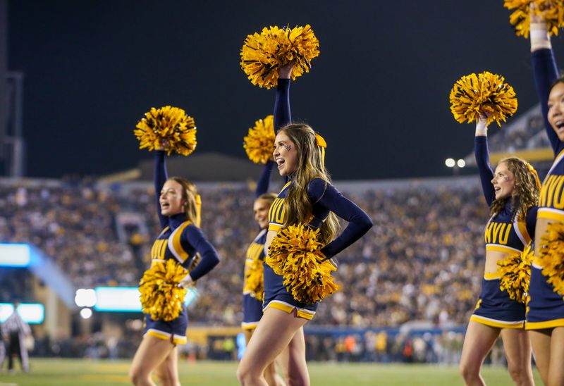 Nov 4, 2023; Morgantown, West Virginia, USA; A West Virginia Mountaineers cheerleader performs during the first quarter against the Brigham Young Cougars at Mountaineer Field at Milan Puskar Stadium. Mandatory Credit: Ben Queen-USA TODAY Sports